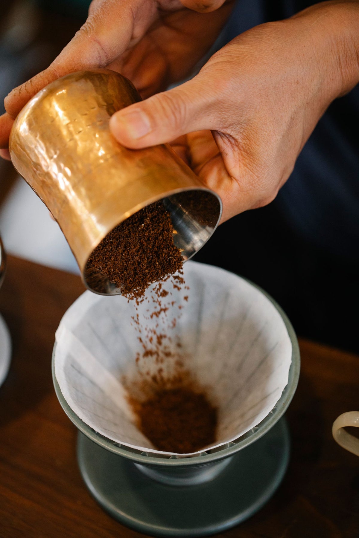 Coffee being slowly brewed in a pour-over dripper in the morning