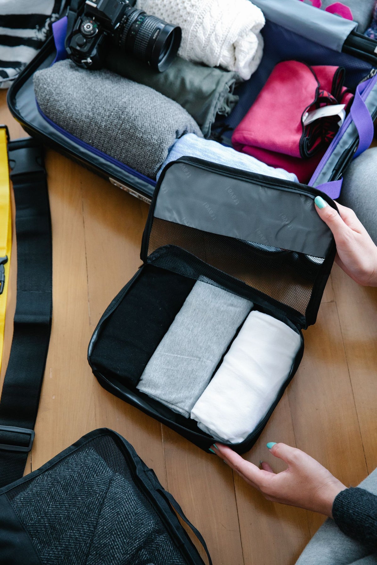 Packing a suitcase neatly with packing cubes
