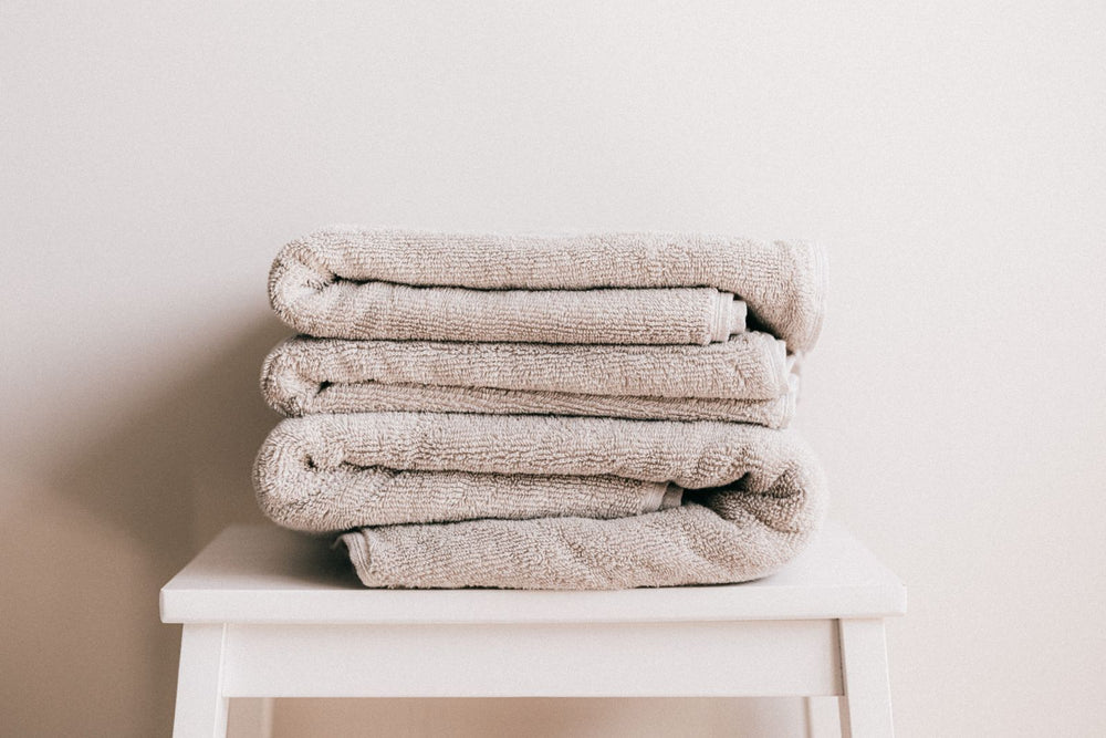 Soft towels stacked on a stool